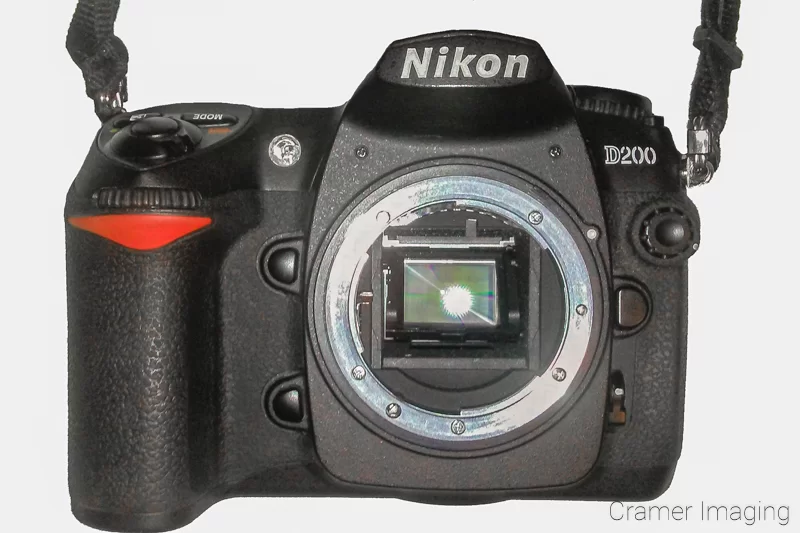 Audrey Cramer Photography's photo of a Nikon D200 camera showing the sensor on a white background