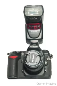 Cramer Imaging's professional quality product photograph of a Nikon DSLR camera with removable flash unit