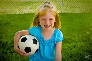 portrait of child holding soccer ball