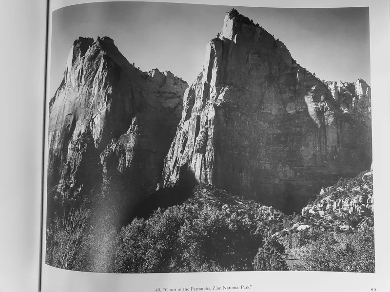 Photo of a book showing Court of the Patriarchs as done by Ansel Adams