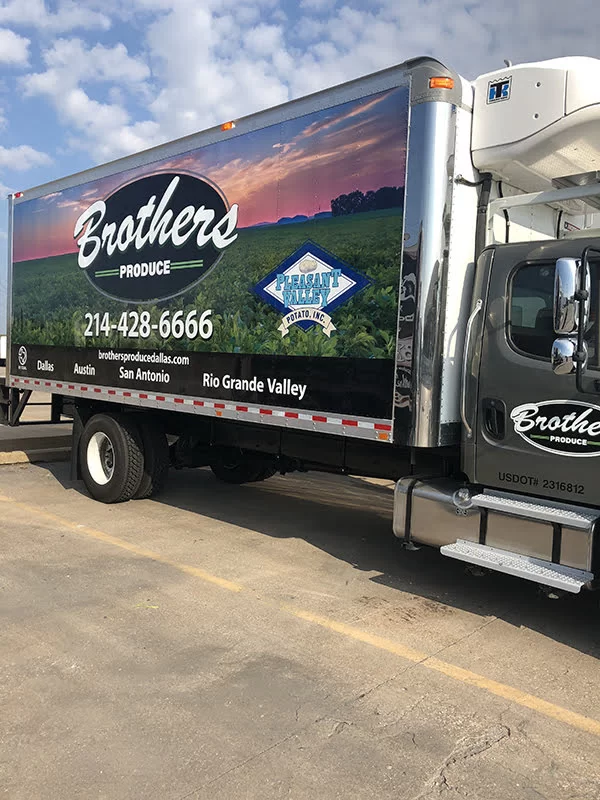 Photograph of Audrey Cramer Photography's potato field at sunrise photo on a Brothers Produce semi-truck