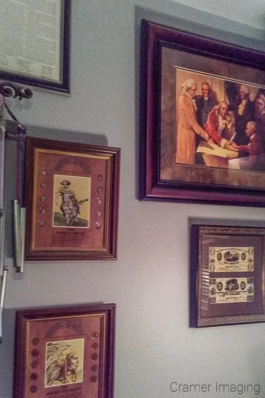 Picture of a wall crowded with pictures in picture frames by Audrey Cramer Photography