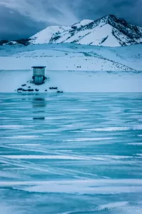 Cramer Imaging's professional quality landscape photograph of scenic Devil's Creek Reservoir or lake frozen with ice and snow