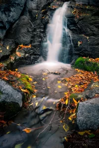 Cramer Imaging's fine art landscape photograph of mini waterfall and pool with fallen autumn leaves