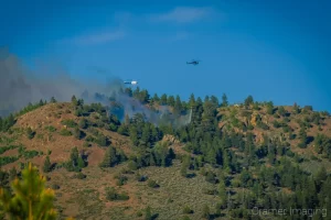 Cramer Imaging's landscape photograph of a helicopter dropping water on a wildfire near Panguitch Lake Utah