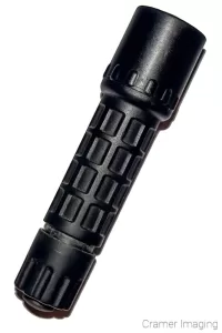 Cramer Imaging's photograph of a black flashlight on a white background