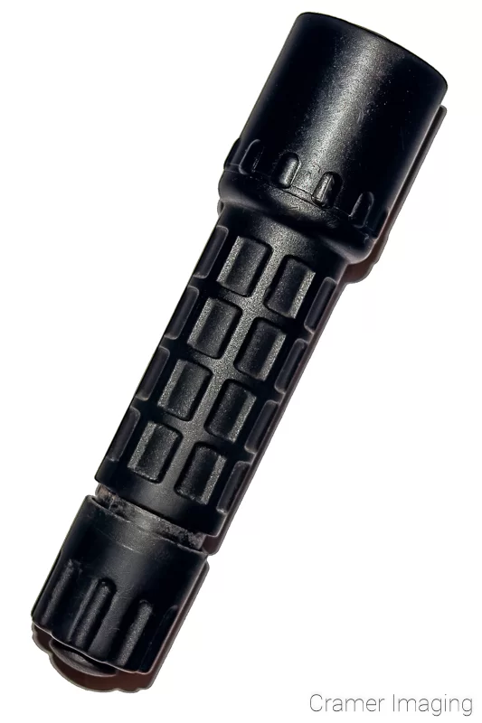 Audrey Cramer Photography's photograph of a black flashlight on a white background