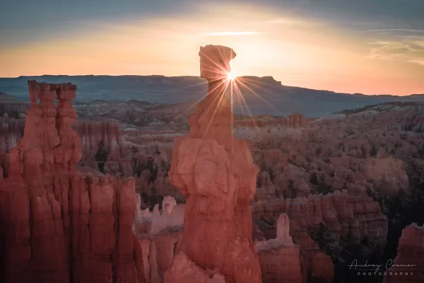 Audrey Cramer Photography's fine art landscape photograph of the sun peeking around the Thor's Hammer hoodoo in Bryce Canyon National Park, Utah