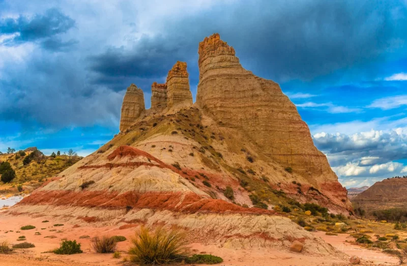 Audrey Cramer Photography's fine art landscape photograph of a giant rock formation against dramatic skies in Cannonville Utah