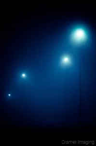 Cramer Imaging's professional quality fine art photograph of four blue-toned street lights in the dark and fog of Pocatello, Bannock, Idaho