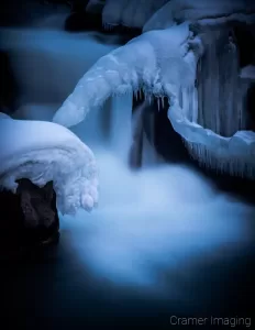 Cramer Imaging's nature photograph of a silky waterfall in the snow during winter in Idaho Falls, Idaho