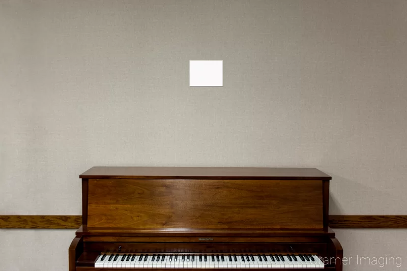 A4 or letter-sized paper on the wall over a piano for sizing purposes