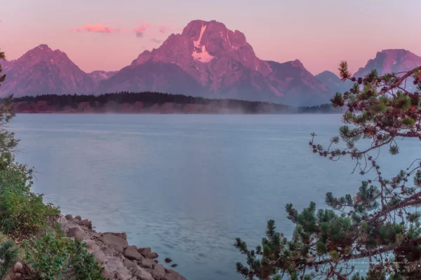 Cramer Imaging's quality landscape photograph of Jackson Lake reservoir with mist at sunrise in Grand Teton National Park Wyoming