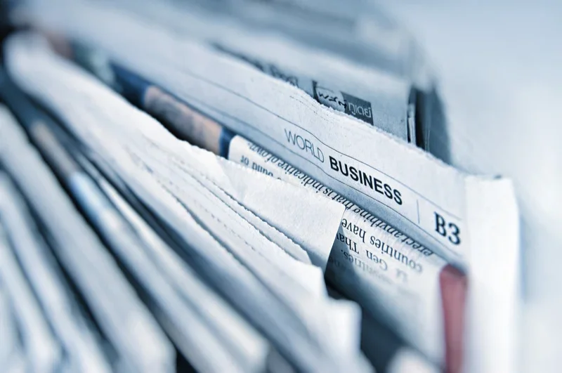 Closeup photograph of a stack of newspapers standing up