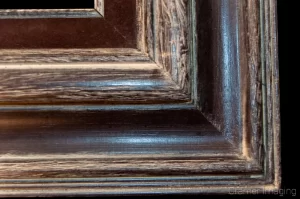 Cramer Imaging's photograph of a single ornate wooden picture frame corner on a black background