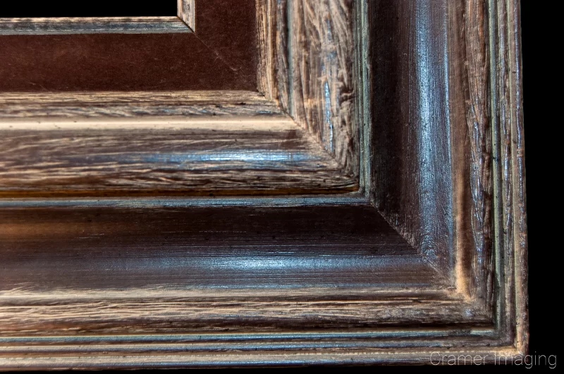 Audrey Cramer Photography's photograph of a single ornate wooden picture frame corner on a black background