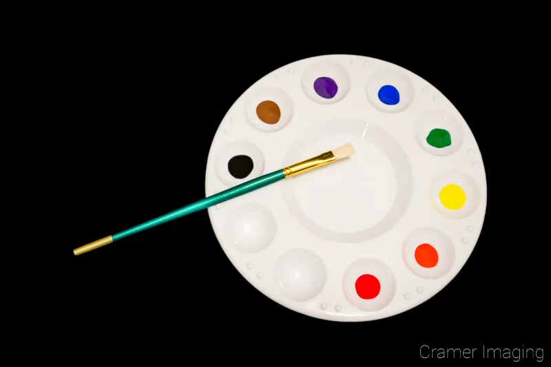 Audrey Cramer Photography's stock photograph of paint, a paintbrush, and a palette on a black background