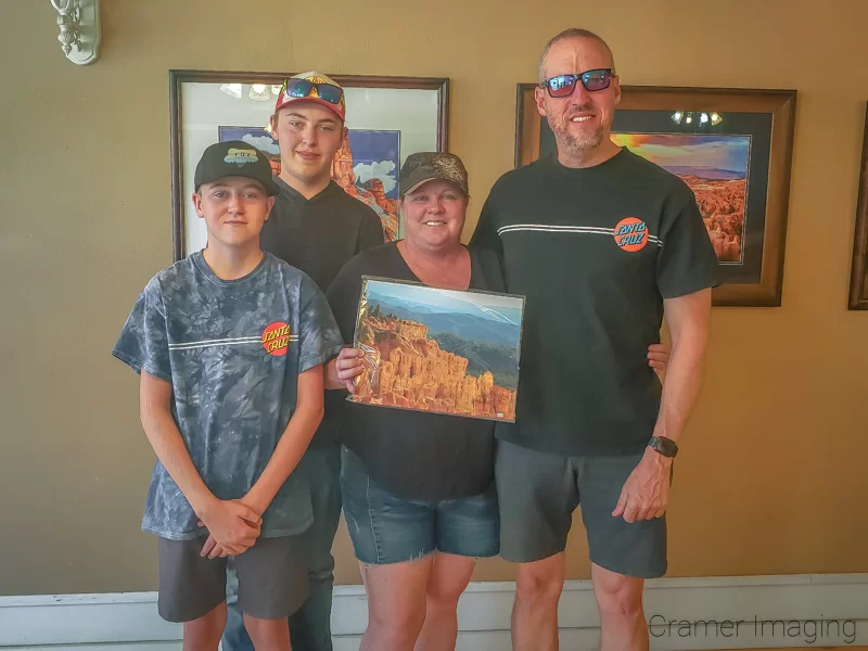 The Panguitch Art Gallery's first customers with their landscape photo purchase