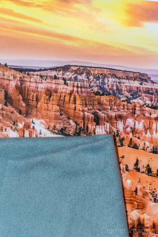 Photograph of a desert landscape photo print and a piece of microfiber cloth for removing fingerprints by Audrey Cramer Photography