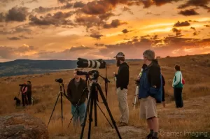 Cramer Imaging's photograph of photographers with cameras waiting for a landscape shot with a sunset behind in Tetonia, Idaho