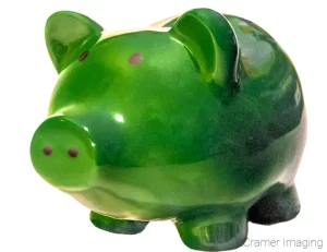 Green piggy bank on white background photograph by Cramer Imaging