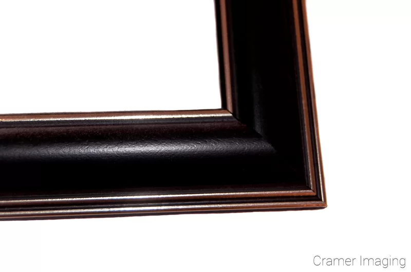 Audrey Cramer Photography's photograph of a single navy-blue colored plastic picture frame corner on a white background