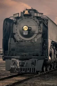 Cramer Imaging's fine art photograph of the Union Pacific 844 Steam Engine on a train track at sunset