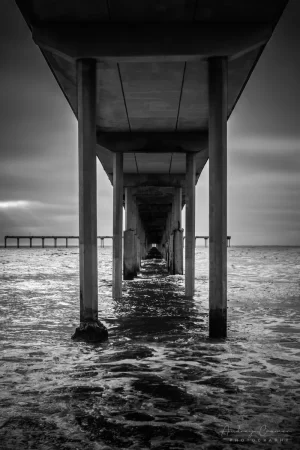 Cramer Imaging's quality black and white landscape photograph of the Pacific Ocean under the San Diego California pier