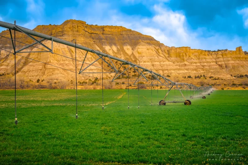 Fine art landcape photograph of a pivot line watering a hay field in Cannonville Utah by Audrey Cramer Photography