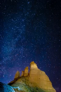 Fine Art landscape photograph of the Milky Way shines over a rock formation at night in Utah by Cramer Imaging