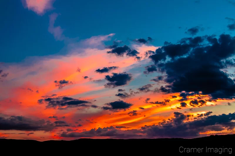 Cramer Imaging's professional quality nature cloudscape photograph of a colorful sunset lighting up clouds