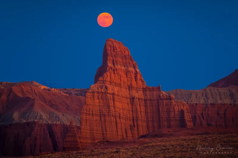 Cramer Imaging's professional landscape photograph of a red moon rising over the Temple of the Moon in Capitol Reef National Park Utah