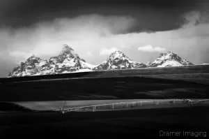 Cramer Imaging's professional quality nature landscape photograph of the Teton mountain peaks and a farm field near Driggs, Idaho