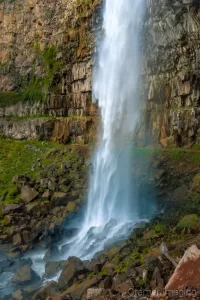 Cramer Imaging's fine art landscape photograph of a waterfall cascading down in a canyon onto rocks in Twin Falls Idaho