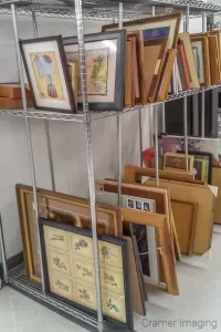 Photo of the second-hand art selection available for sale at a local thrift store by Cramer Imaging