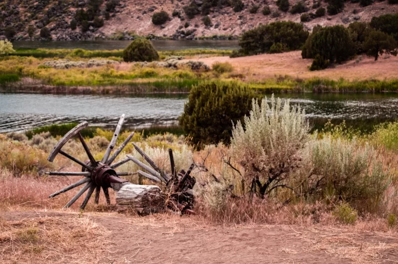 Audrey Cramer Photography's professional quality natural scenic landscape photograph of wagon wheels, axle, and sagebrush on the Snake River at Massacre Rocks, Idaho