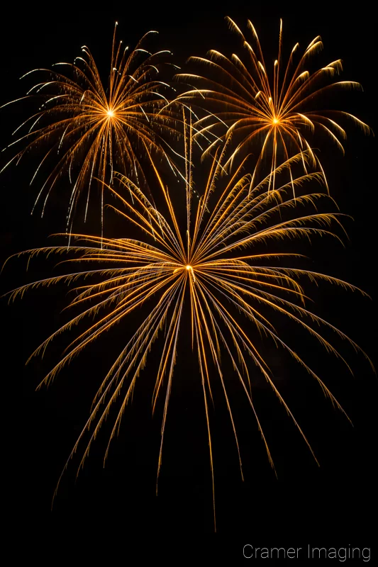 Audrey Cramer Photography's fine art photograph of three fireworks in the night sky on the 4th of July