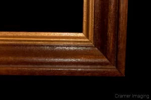 Cramer Imaging's photograph of a single brown wooden picture frame corner on a black background