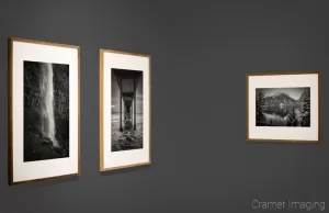 Cramer Imaging's photograph of three framed monochrome fine art landscape photographs on a grey gallery wall