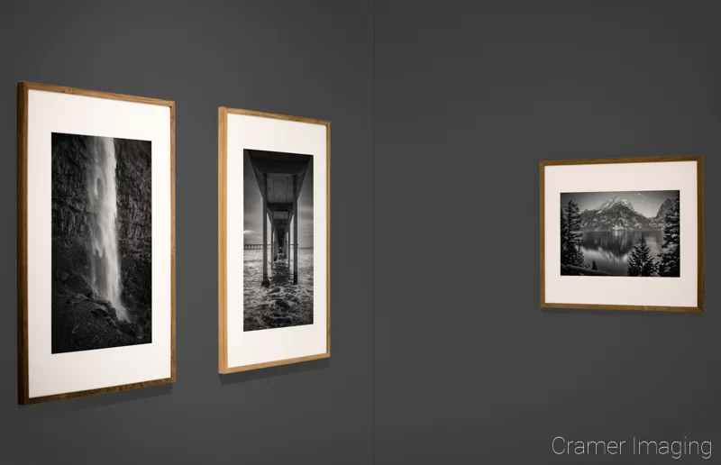 Audrey Cramer Photography's photograph of three framed monochrome fine art landscape photographs on a grey gallery wall