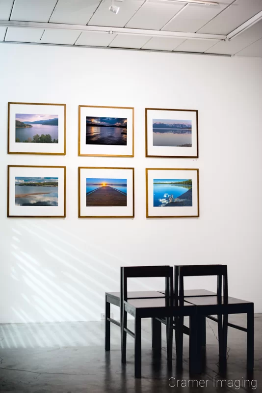 Audrey Cramer Photography's photograph of six framed landscape photographs from the Grand Teton Council Collection on a gallery wall