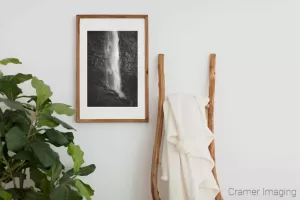 Photograph of Cramer Imaging's fine art photograph 'Shimmering Mist' on the wall of a room with a decorative ladder and a fake plant