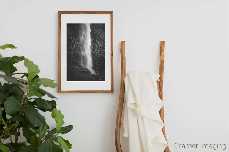 Photograph of Audrey Cramer Photography's fine art photograph 'Shimmering Mist' on the wall of a room with a decorative ladder and a fake plant