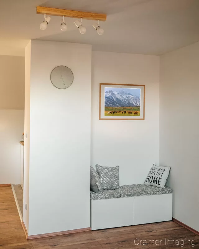 Photograph of Audrey Cramer Photography's landscape photo titled "Tetons and Horses" framed and hanging in a nook