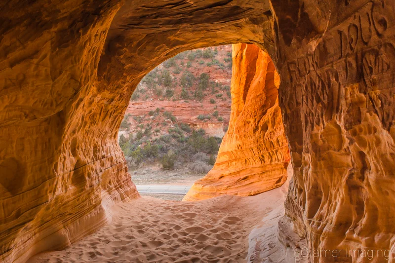 Audrey Cramer Photography's fine art landscape photograph of graffiti carved into the walls of the Moqui sand caverns cave entrance