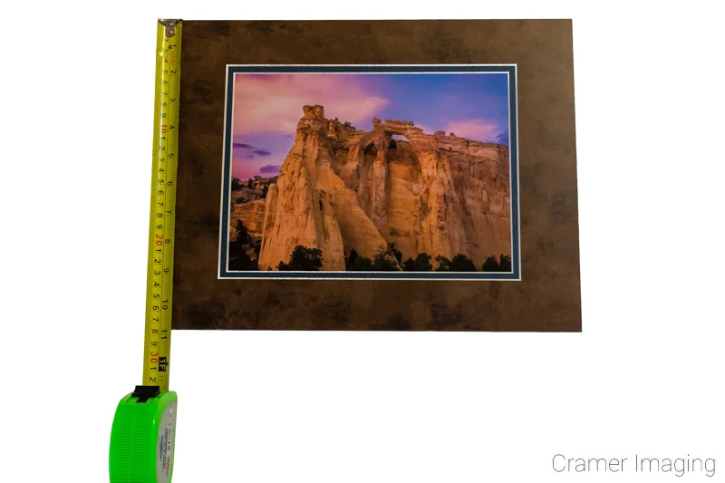 Photograph of a matted Audrey Cramer Photography print of "Grosvenor Sunset" measured with a tape measure