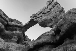 Cramer Imaging's fine art monochrome landscape photograph of a high arch of rock in Red Canyon, Utah