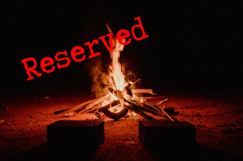 Graphic of a roaring campfire at night with 2 seats in front with a red reserved stamp across it