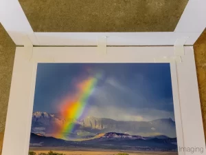 Photo of Cramer Imaging's landscape photograph titled "Broken Rainbow sitting in an open hinged mat showing tape positions