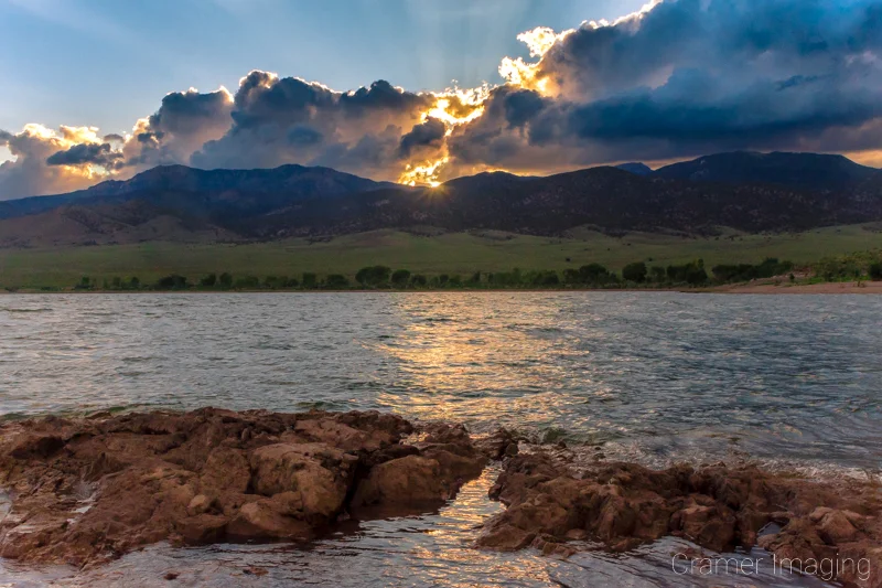 Cramer Imaging's fine art landscape photograph of the sun setting behind clouds at Piute State Park Utah